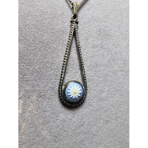 230 - A 925 hallmarked silver pendant with a blue bisque flower insert set on a good 18