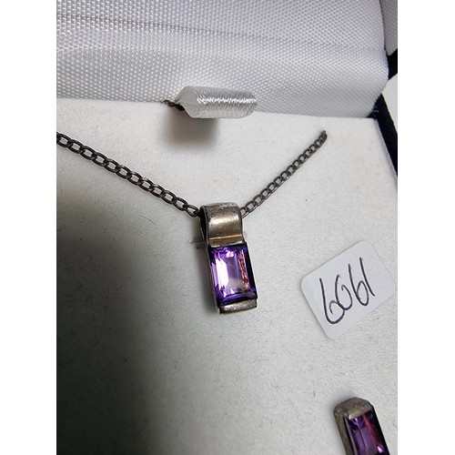 193 - A 925 silver matching jewellery set to include a 925 silver pendant inset with an amethyst stone on ... 