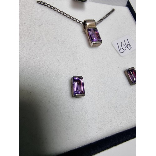 193 - A 925 silver matching jewellery set to include a 925 silver pendant inset with an amethyst stone on ... 