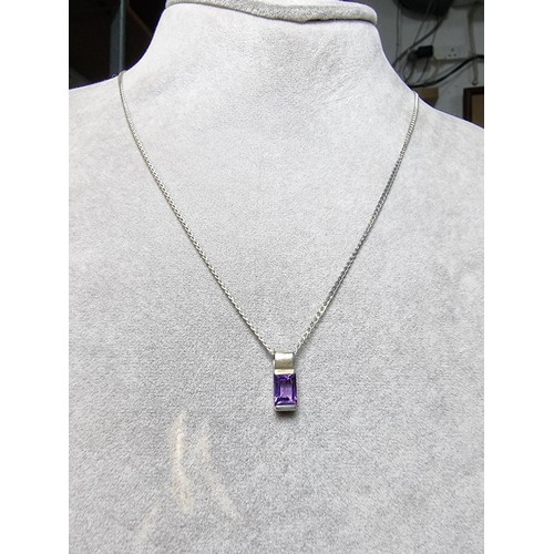 193 - A 925 silver matching jewellery set to include a 925 silver pendant inset with an amethyst stone on ... 