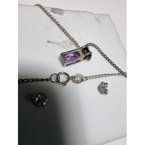 193 - A 925 silver matching jewellery set to include a 925 silver pendant inset with an amethyst stone on ... 