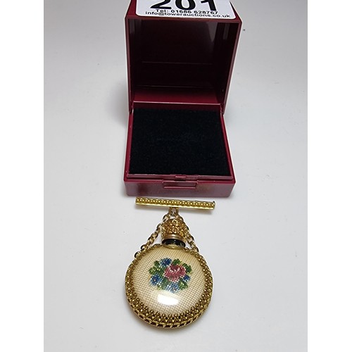 201 - A pretty vintage gilt scent bottle brooch with an ornate design having an embroidered floral scene t... 