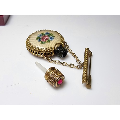 201 - A pretty vintage gilt scent bottle brooch with an ornate design having an embroidered floral scene t... 