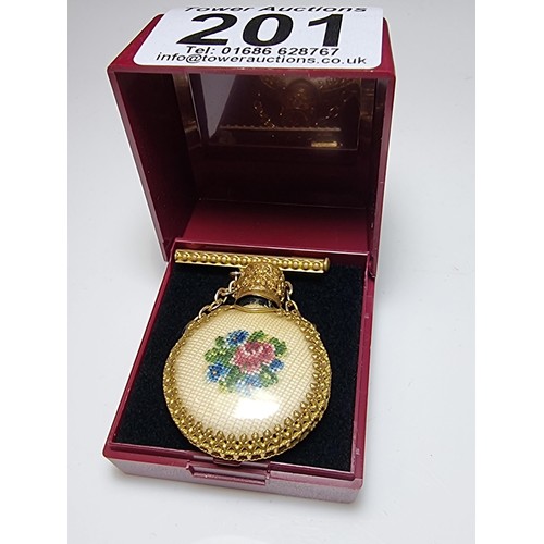 201 - A pretty vintage gilt scent bottle brooch with an ornate design having an embroidered floral scene t... 