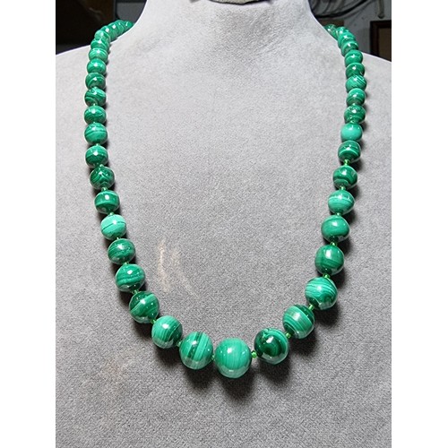 203 - An impressive Malachite beaded necklace with a graduating design, the malachite beads present an exc... 