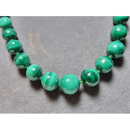 203 - An impressive Malachite beaded necklace with a graduating design, the malachite beads present an exc... 