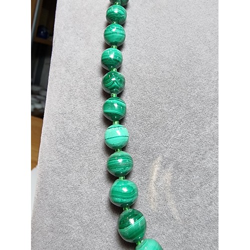 203 - An impressive Malachite beaded necklace with a graduating design, the malachite beads present an exc... 