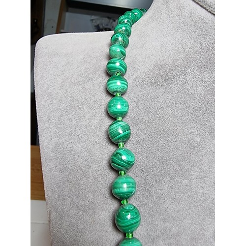 203 - An impressive Malachite beaded necklace with a graduating design, the malachite beads present an exc... 