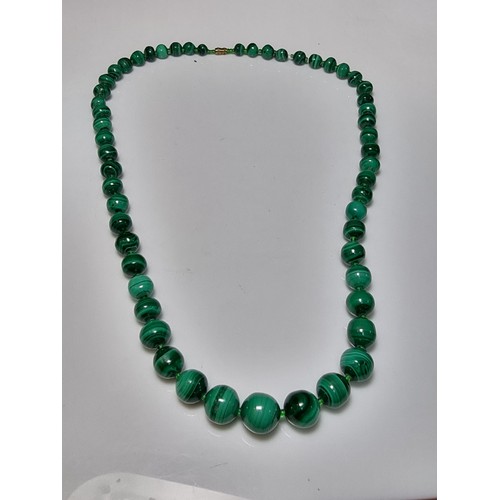 203 - An impressive Malachite beaded necklace with a graduating design, the malachite beads present an exc... 