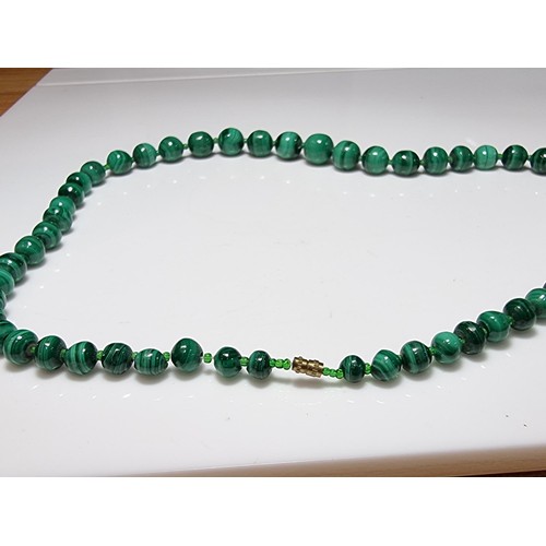 203 - An impressive Malachite beaded necklace with a graduating design, the malachite beads present an exc... 