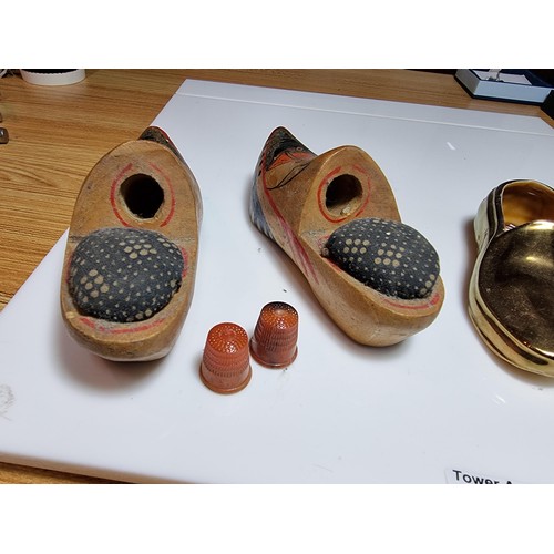 206 - A pair of vintage wooden clog formed pin cushions with thimbles along with a pair of gilt ceramic La... 