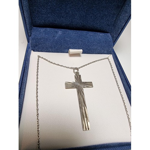 208 - A 925 silver Cross pendant with an engraved design on an 18