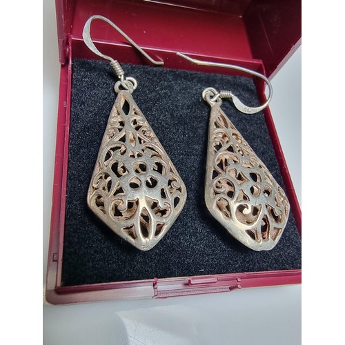 214 - A pair of pretty 925 silver drop earrings with an ornate pierced design. Length of the drop is 3.5cm... 