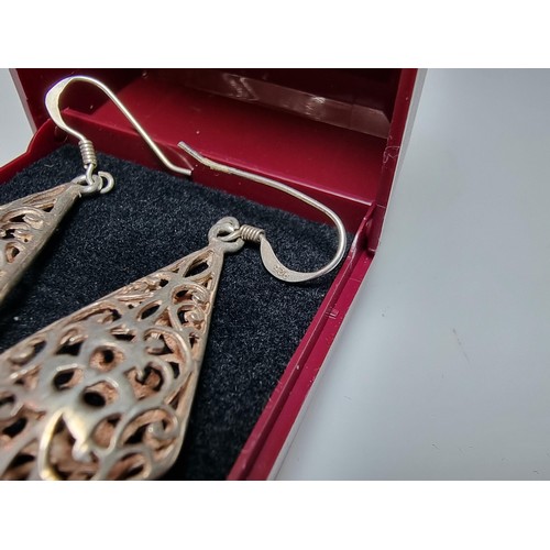 214 - A pair of pretty 925 silver drop earrings with an ornate pierced design. Length of the drop is 3.5cm... 