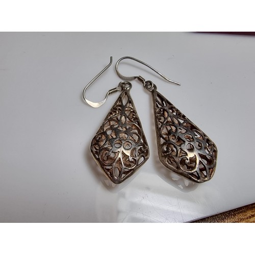 214 - A pair of pretty 925 silver drop earrings with an ornate pierced design. Length of the drop is 3.5cm... 