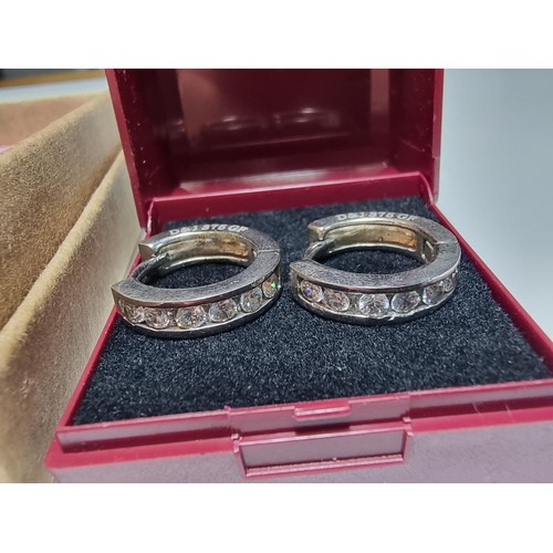 216 - A pair of 9ct white gold filled hoop earrings with CZ crystal stones along with a 21st birthday 925 ... 