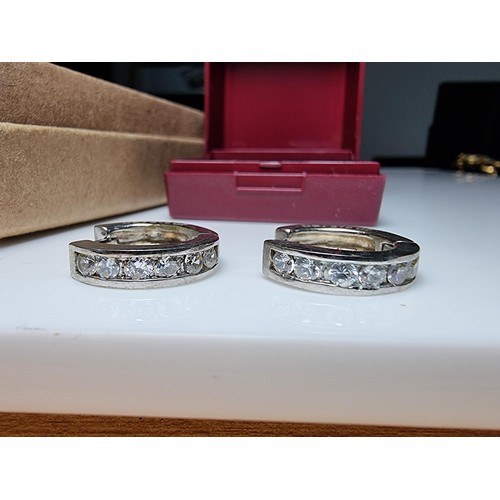 216 - A pair of 9ct white gold filled hoop earrings with CZ crystal stones along with a 21st birthday 925 ... 