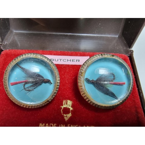 217 - A pair of vintage gilt cufflinks both inset with a genuine fishing fly, cased and ideal for a fisher... 