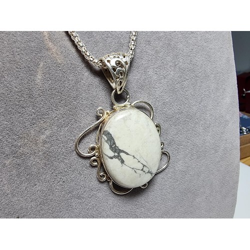 218 - A good quality 925 silver large pendant inset with a large oval white Howlite stone set on a very go... 