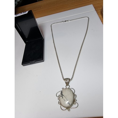 218 - A good quality 925 silver large pendant inset with a large oval white Howlite stone set on a very go... 