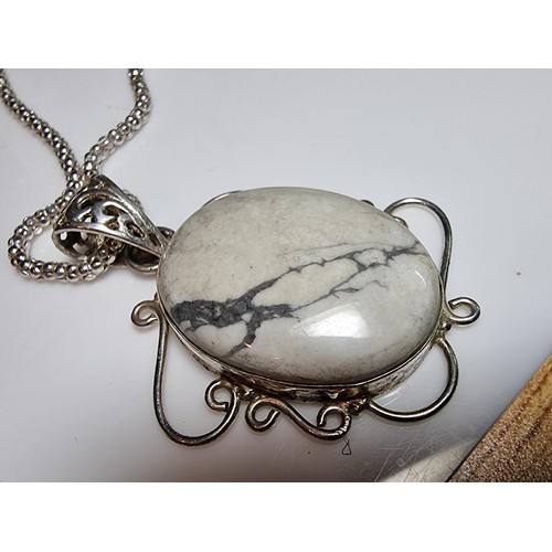 218 - A good quality 925 silver large pendant inset with a large oval white Howlite stone set on a very go... 