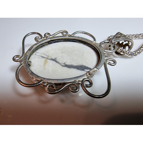 218 - A good quality 925 silver large pendant inset with a large oval white Howlite stone set on a very go... 