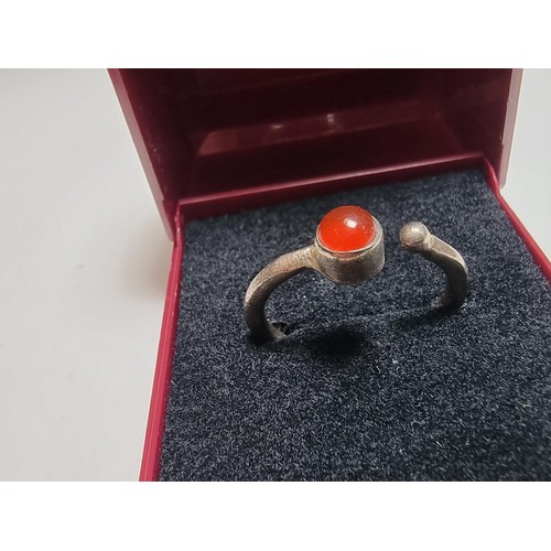 221 - A 925 silver adjustable ring inset with a Carnelian stone, the ring is indistinctly marked 925 but d... 