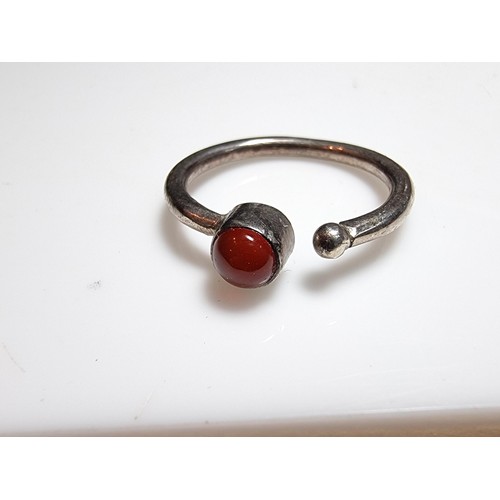 221 - A 925 silver adjustable ring inset with a Carnelian stone, the ring is indistinctly marked 925 but d... 