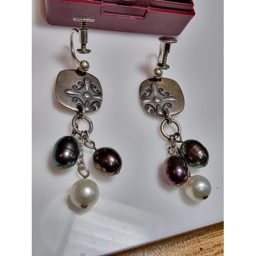 222 - A pair of 925 silver screw back drop earrings inset with 3 genuine pearls on each, in excellent clea... 