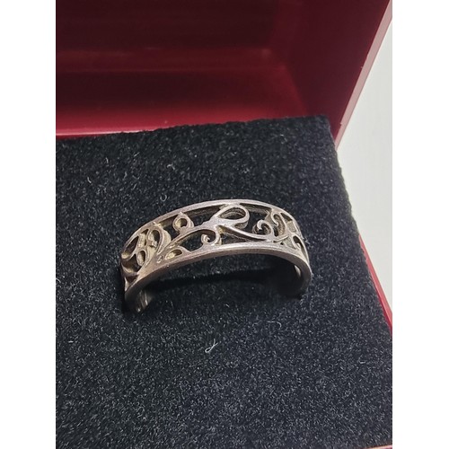 223 - A 925 silver ring with an ornate pierced design, in good clean condition and boxed, size Q.