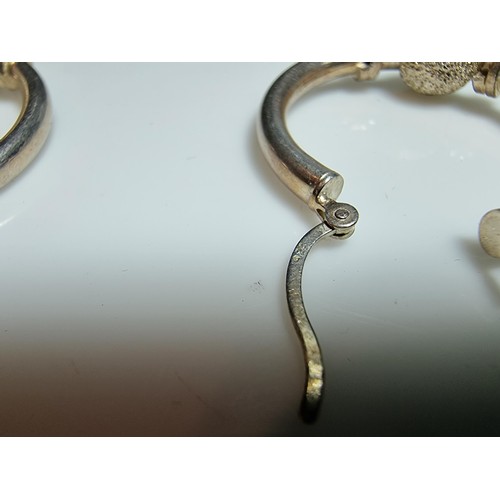 228 - A pair of 925 silver hoop earrings with a glittery ball design. In good clean condition, boxed. Diam... 