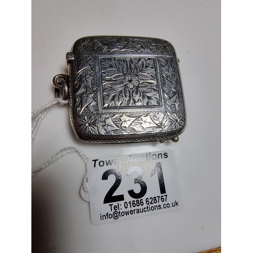 231 - A good quality antique hallmarked silver vesta case with an ornate engraved design to both sides, fe... 