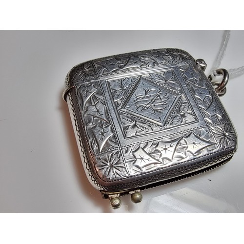 231 - A good quality antique hallmarked silver vesta case with an ornate engraved design to both sides, fe... 