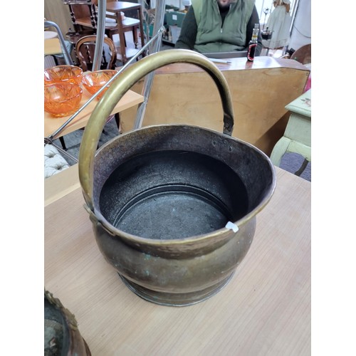 380 - Large brass double handled brass coal bucket along with a smaller double handled copper coal bucket,... 