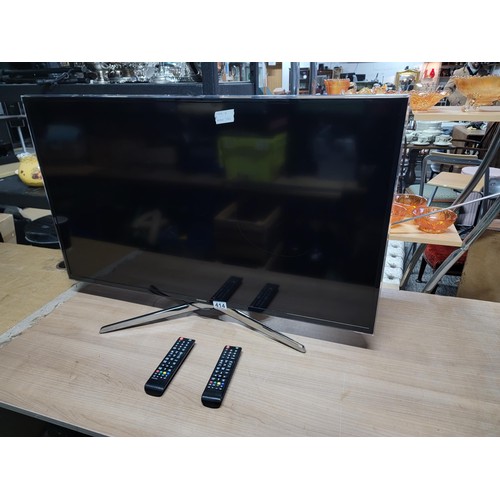 414 - Samsung 40 inch flat screen TV complete with power cable and remote controls standing on a chrome st... 