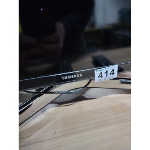 414 - Samsung 40 inch flat screen TV complete with power cable and remote controls standing on a chrome st... 