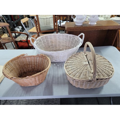 429 - 3x wicker baskets inc a wicker hamper in good order largest basket measures 24cm by 58cm