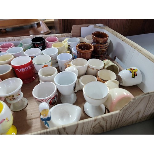 437 - Box containing a large quantity of 30 plus egg cups of various designs inc train formed, dog, rabbit... 