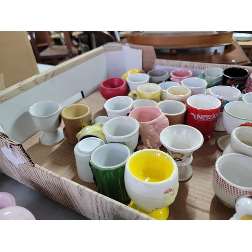 437 - Box containing a large quantity of 30 plus egg cups of various designs inc train formed, dog, rabbit... 