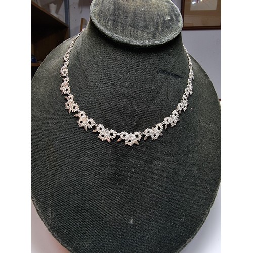 238 - A pretty 925 silver necklace with a floral design in excellent clean condition, complete with safety... 