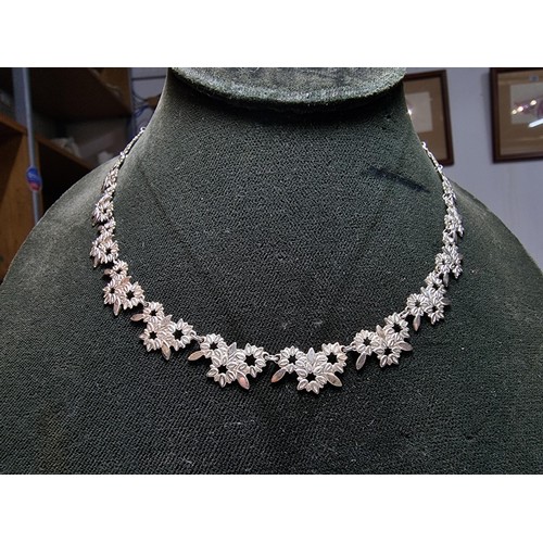 238 - A pretty 925 silver necklace with a floral design in excellent clean condition, complete with safety... 