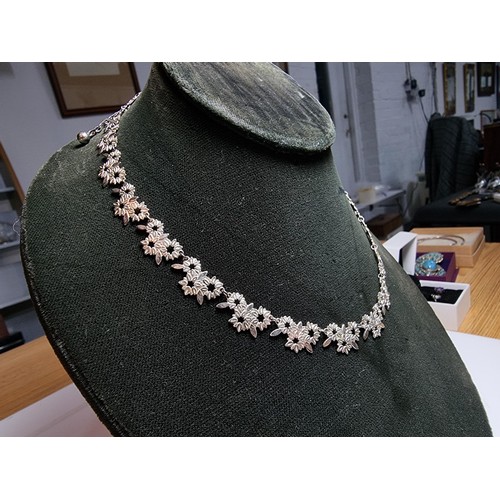 238 - A pretty 925 silver necklace with a floral design in excellent clean condition, complete with safety... 