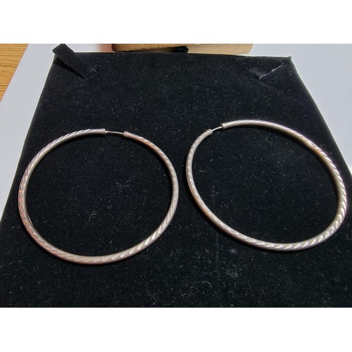 240 - A pair of good large 925 silver hoop earrings with an engraved design. In good clean condition, boxe... 