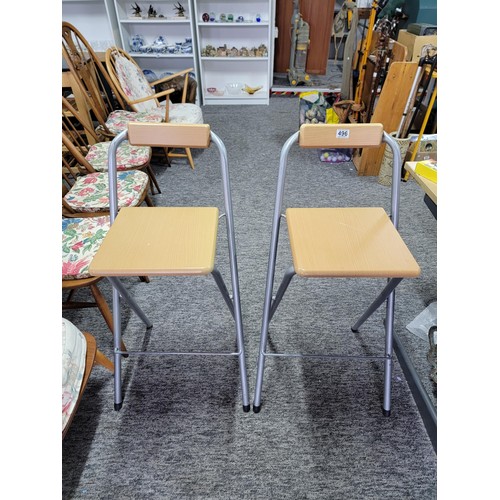 496 - 2 folding bar stools with silver coloured steel frames and solid timber seats both in good order