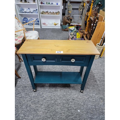 502 - 2 drawer kitchen unit on castors, green painted wood with pine top in good order.