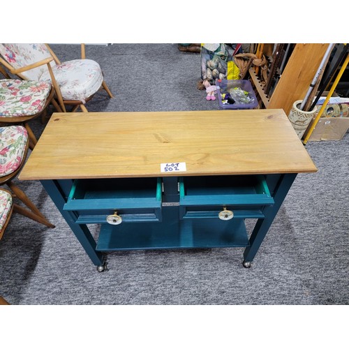 502 - 2 drawer kitchen unit on castors, green painted wood with pine top in good order.