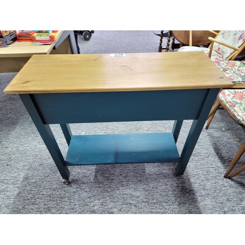 502 - 2 drawer kitchen unit on castors, green painted wood with pine top in good order.