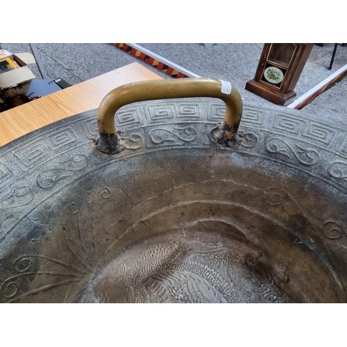 273 - A large antique Chinese bronze singing bowl with a dragon design featuring a yin yang and character ... 