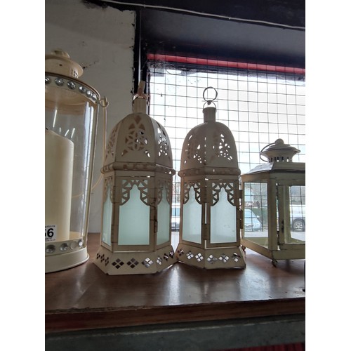 456 - A collection of 5 various lanterns, one has a jewelled rim holding a large pillar candle tallest sta... 