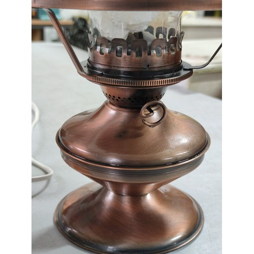 456B - Good quality brushed copper effect paraffin lamp complete with shade and chimney along with a rock c... 